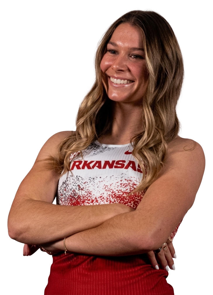 Ainsley Erzen smiling in her University of Arkansas track uniform